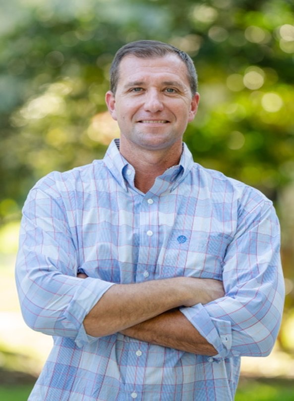 Mike Sobieski, founder of Premier Leak Detection, standing in front of a forest with his arms crossed, ready to take on your leak detection project.